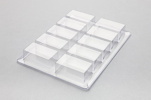 A Munot Plastics compartment tray against a solid gray background.